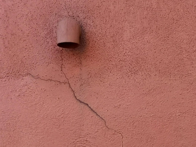 Red stucco wall with a crack on a Tucson Home